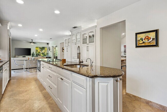 Gourmet kitchen with granite countertops & white raised panel wood cabinetry - 2535 NW 41st St