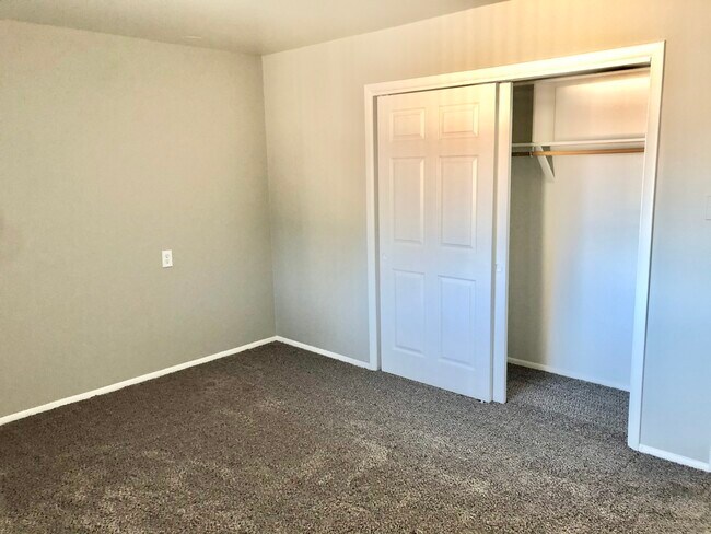 Step into a warm bedroom with ample closet space and cozy carpeting. - GRACE LANDINGS APARTMENTS