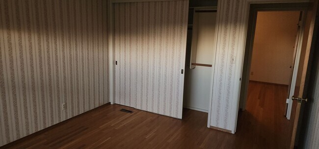 Building Photo - This is a spacious house featuring four bedrooms and two bathrooms, along with a two-car garage.