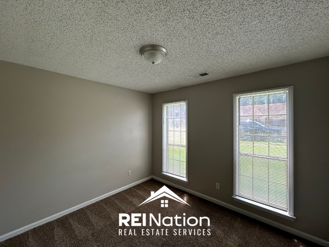 Building Photo - Spacious 4BR/2BA Near Southwind | High Ceilings, Brick Fireplace & 2-Car Garage