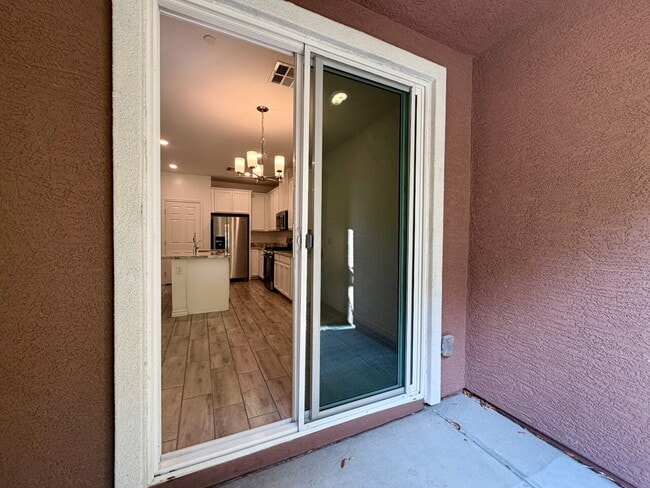 Building Photo - GATED 3 BED 2.5 BATH TOWNHOME WITH 2-CAR GARAGE, COVERED PATIO & COMMUNITY POOL