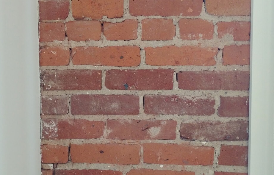 Master bedroom architectural detail wall with original exposed brickwork - 100 W Market St