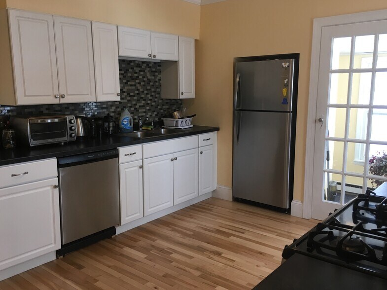 Opposite side of kitchen. Doorway to right is 3-season porch with attic access for utilities (not storage). - 1320 Jefferson St NE