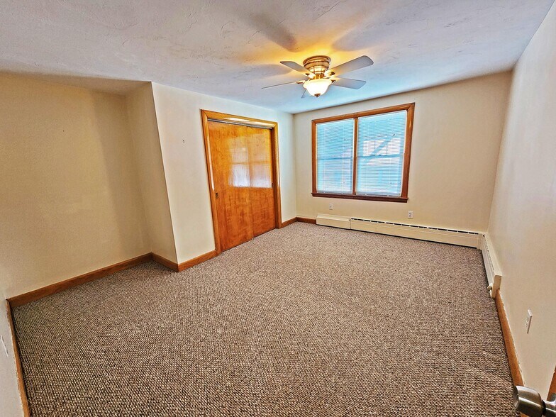 Primary bedroom with ceiling fan - 216 5th St
