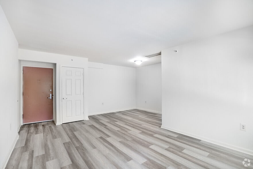 3BR, 1.5BA - 878SF - Living Room & Dining Room - Highland Terrace Apartments