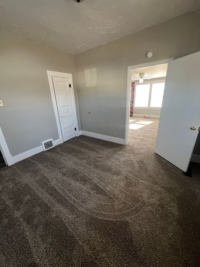 Building Photo - Spacious-Charming-Two Plus Bedrooms-Sunny Windows-Fenced Yard-Pet Family Members Welcome!