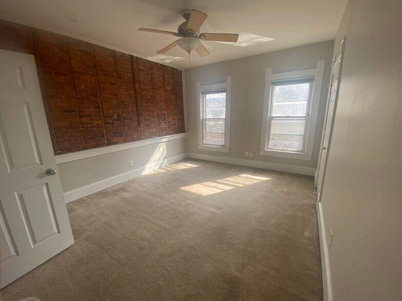 Bedroom 1 with brick wall - 1003 Broadway St