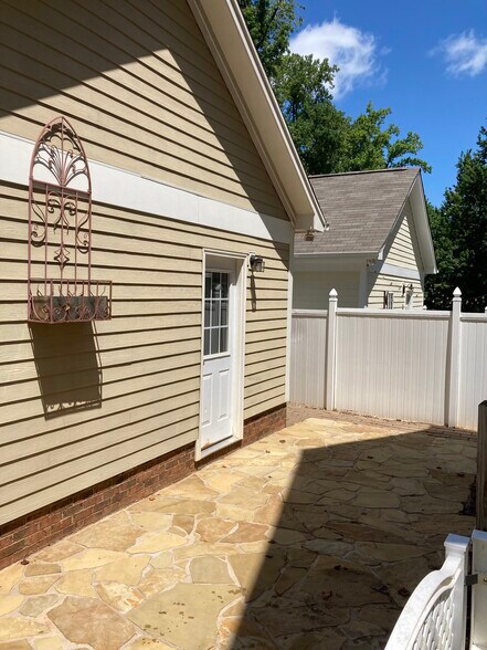 Backyard with stone patio and deck - 133 Kensington St