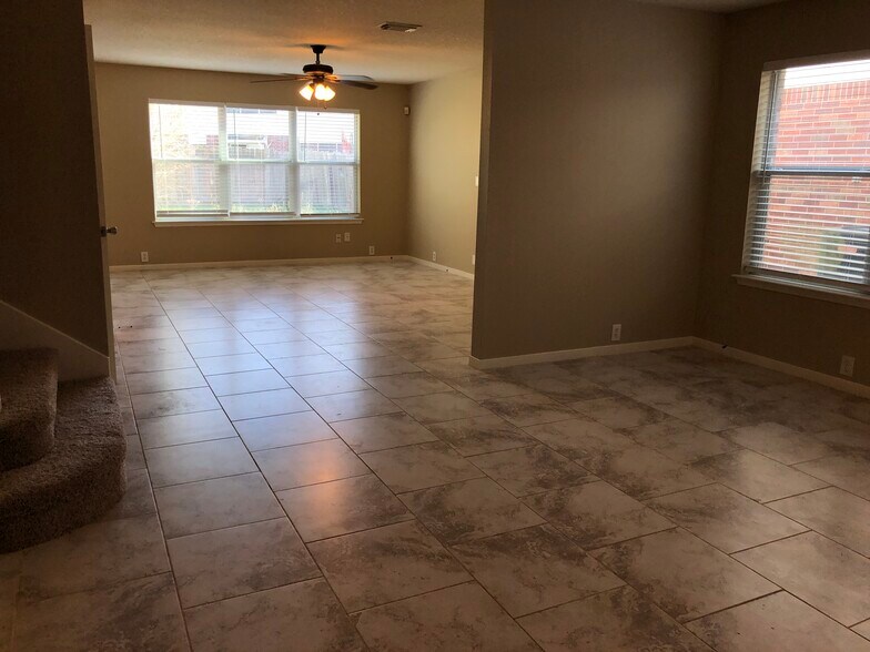 A view of from the home's entry - a formal living/dining room opening into the family room. - 17359 Turquoise Stream Dr
