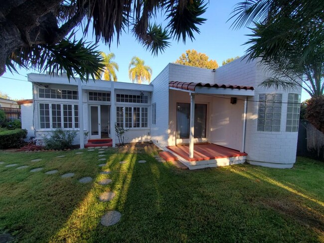 Rear view of front house from back, note large room on left with wall to wall windows - 4231 Chase Ave