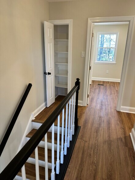 Bright upper-level landing at the top of the wood staircase - 55 Providence Ave