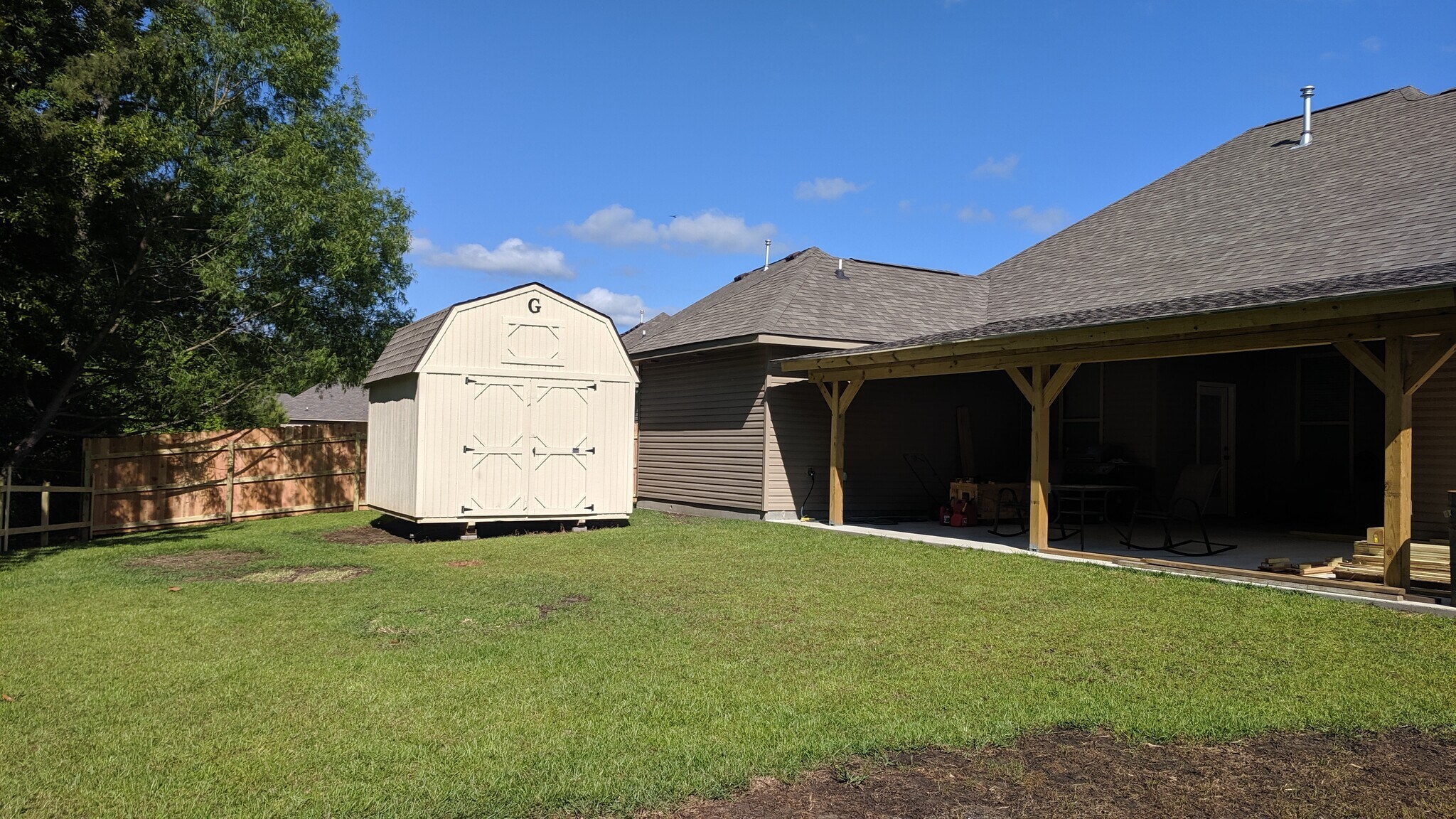 Graceland utility building and covered patio with 2 ceiling fans. - 742 Red Pine Dr