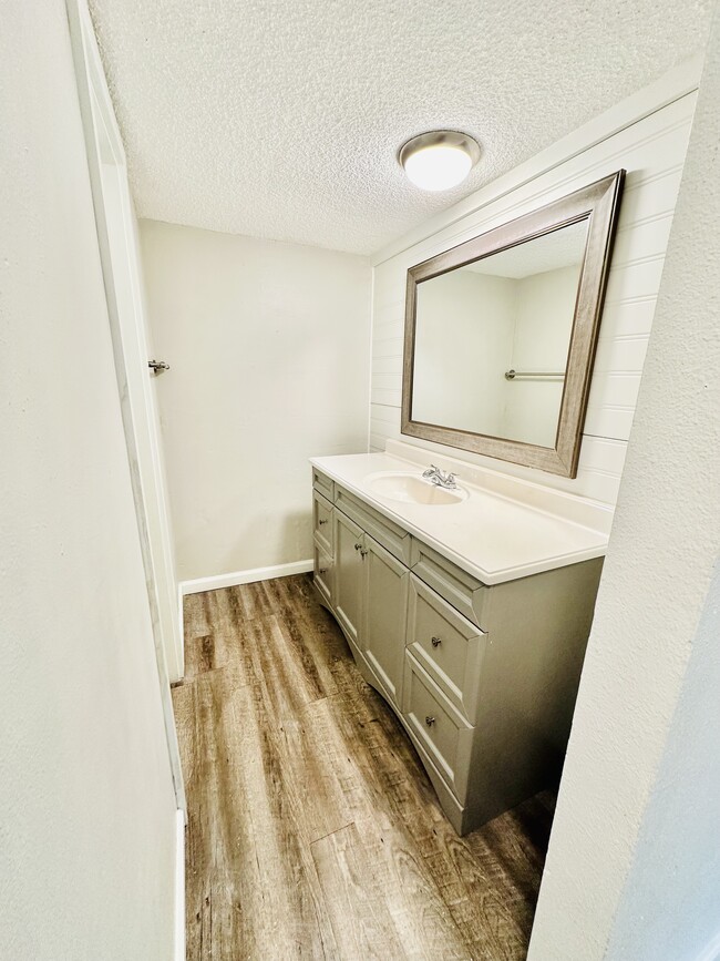 Experience a blend of elegance and functionality in this beautifully designed bathroom. - Hawk Point Apartments