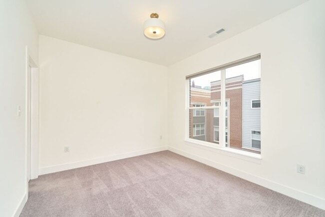Building Photo - Like New Townhome With Your Own Rooftop Views of Downtown Indy!