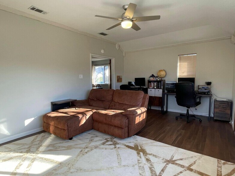 Bonus den with plush sectional and two dedicated work-from-home desks. - 2401 Thistle Ct