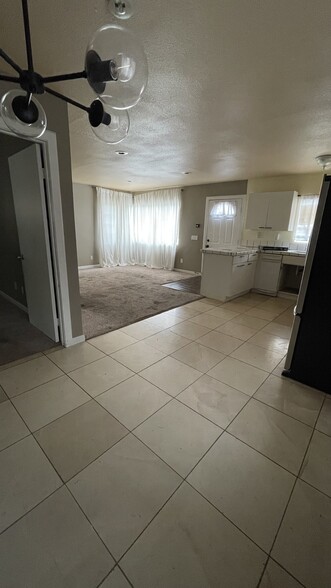View of Living room and kitchen from dining area. - 13947 Meadow Ln