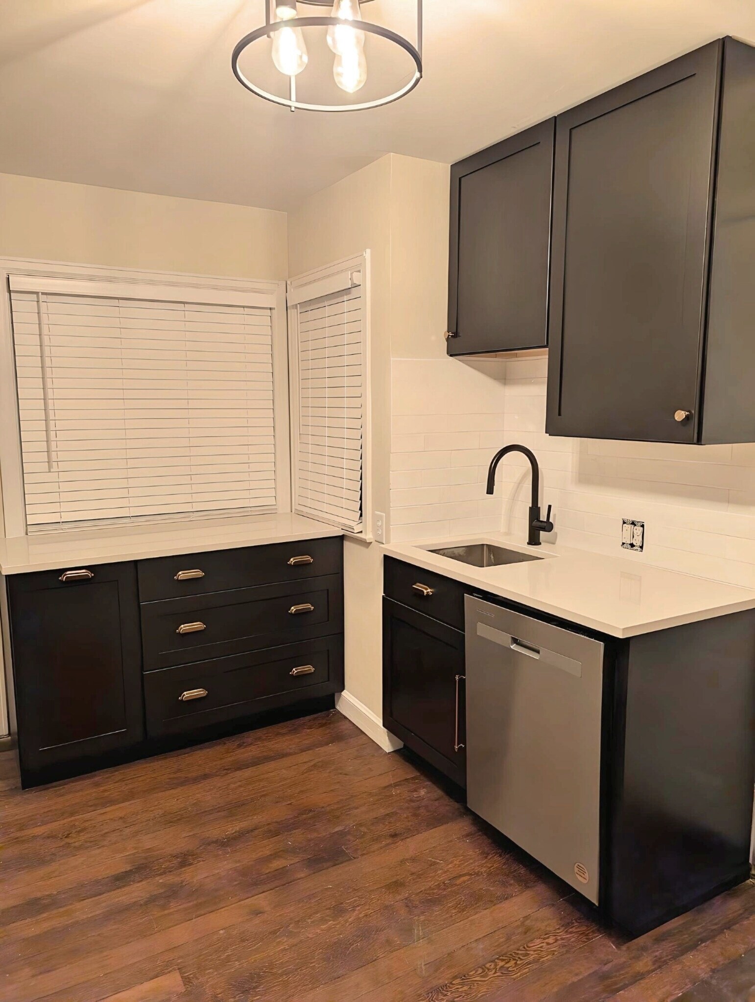 Renovated kitchen with dishwasher, quartz counters and black cabinets. - 2734 N Avondale Blvd