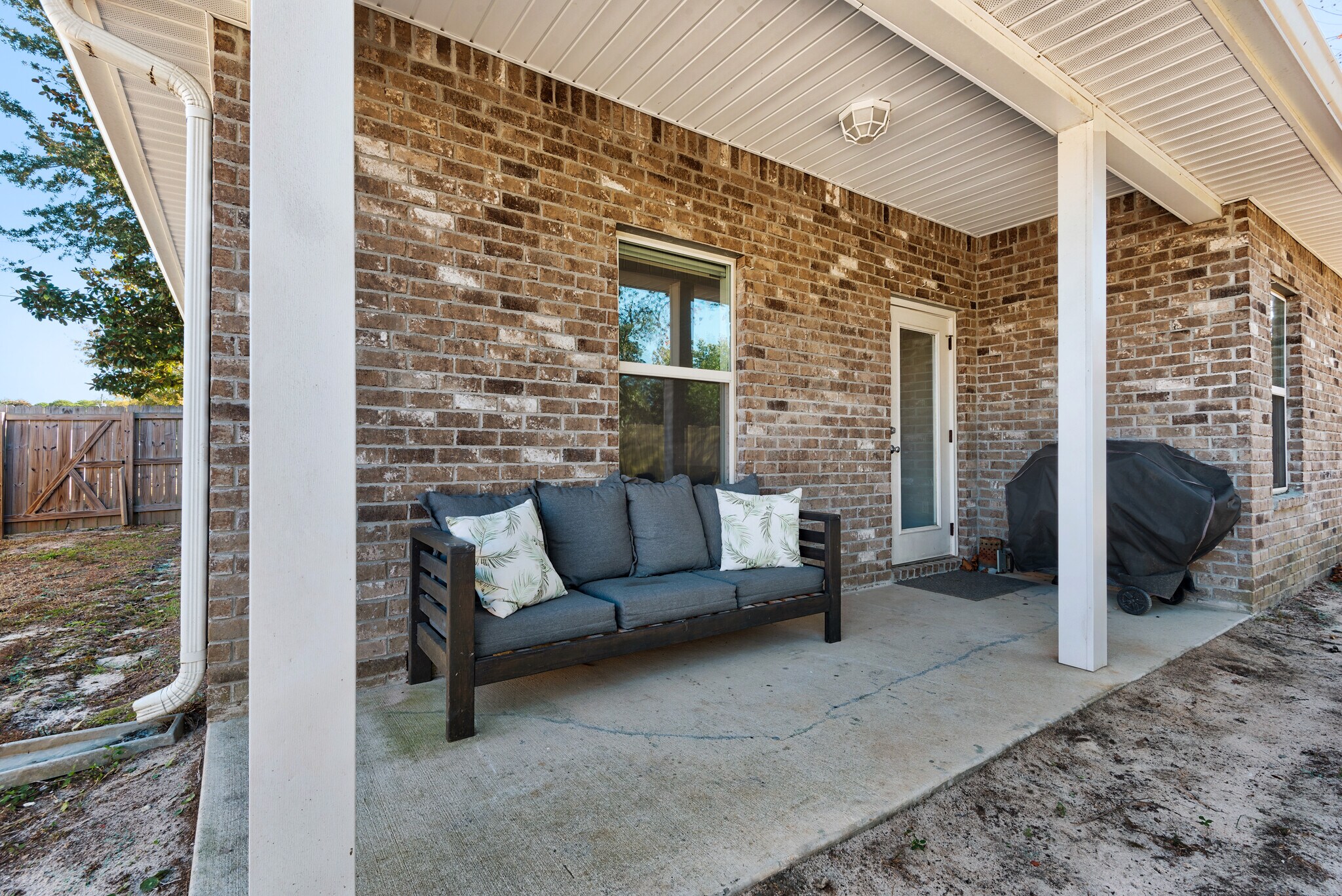 Backyard has a private fence, patio furniture, and barbecue - 28 Snook Rd
