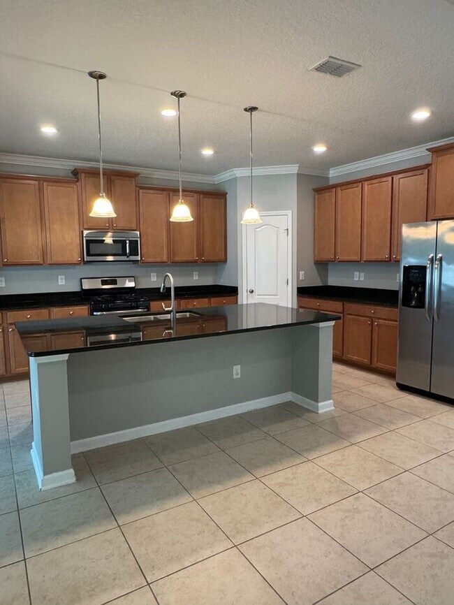 Building Photo - COMING SOON! Beautiful 4BR 3BA Home w/ Screened Lanai & Pond View • Garage Parking • Fenced Yard ...