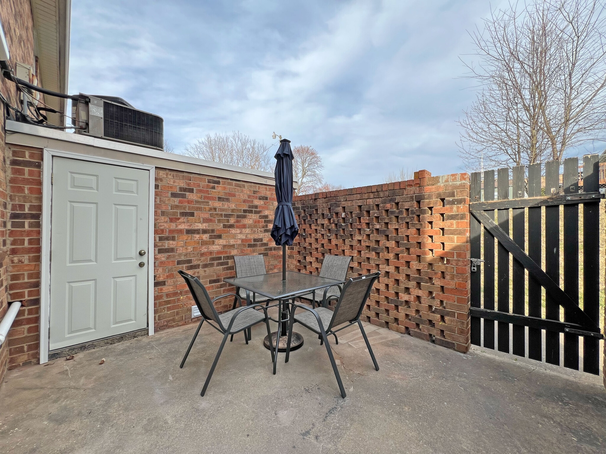 Spacious patio w/4-top table and 7 ft umbrella w/solar lighting / Access door to laundry room - 160 17th Street Pl NW