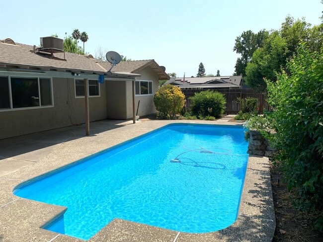 Building Photo - Enjoy the Backyard Pool at This 4-Bedroom ...