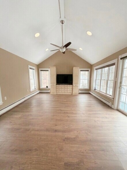 Bright vaulted great room with large windows and direct access to the deck - 16 Miller Rd