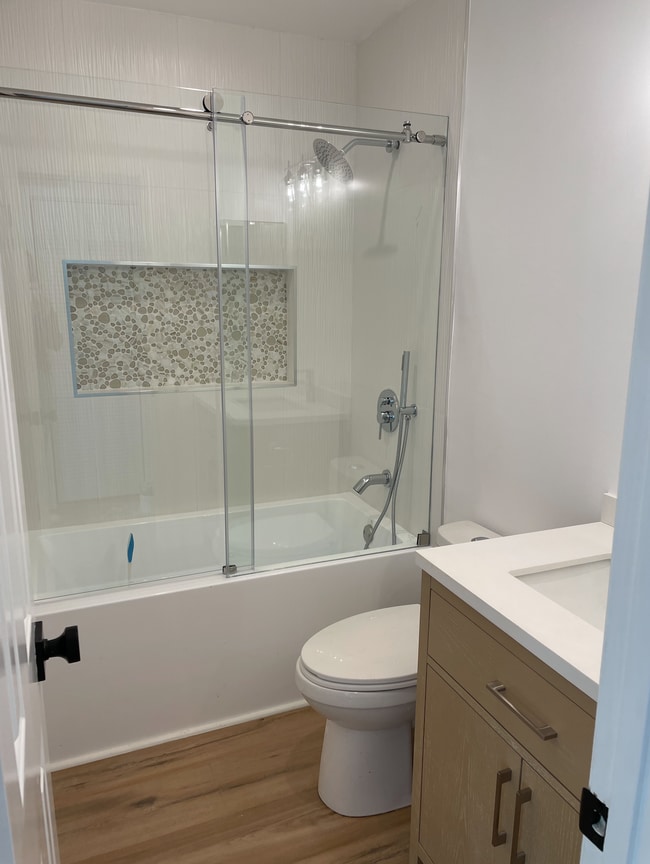Designer tile tub shower with white oak vanity and quartz countertops - 1741 Granville Ave