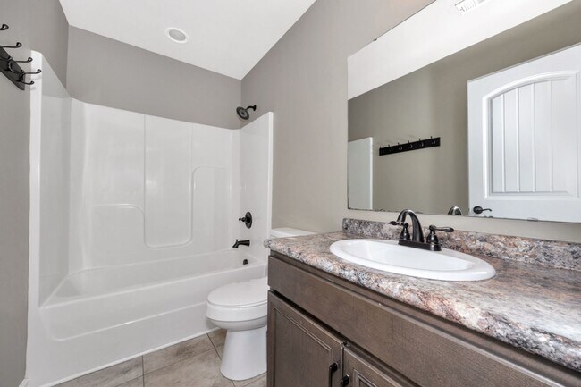 Building Photo - Fresh Paint & New Carpet! 4BR with Fenced Yard