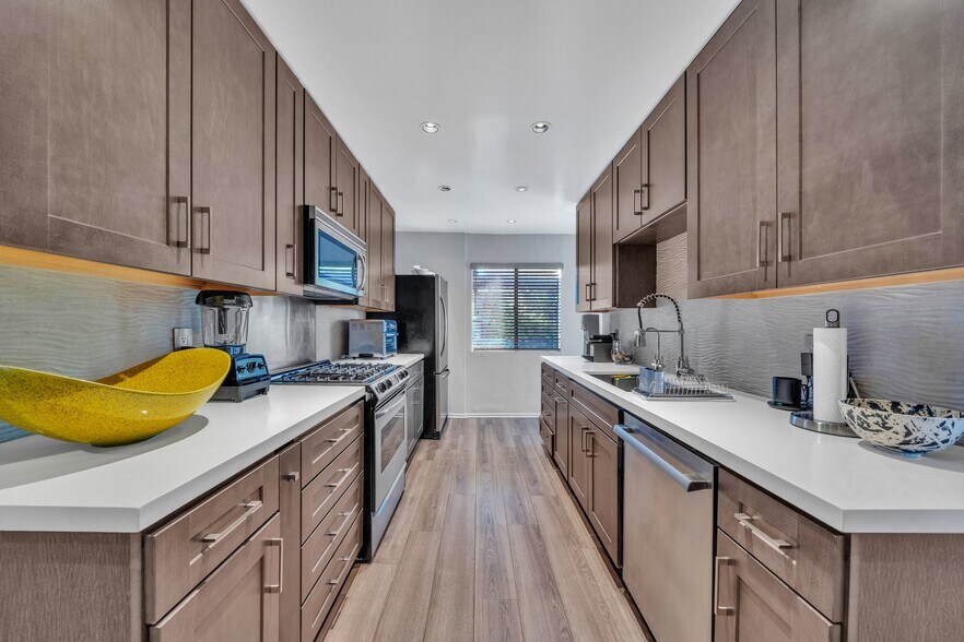 Kitchen with stainless steel appliances - 909 N Sierra Bonita Ave