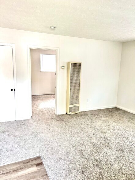 newly carpeted living room with closet storage - 1965 Vaughn St