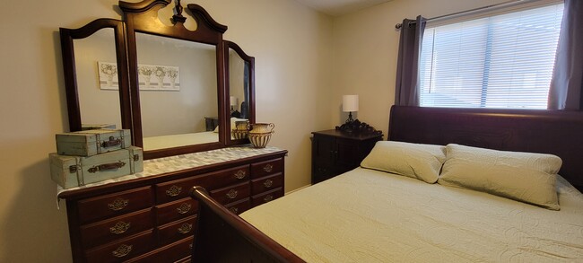 Bedroom #1 with queen bed, room darkening curtains, white noise machine, dresser and closets. - 1522 Parkway