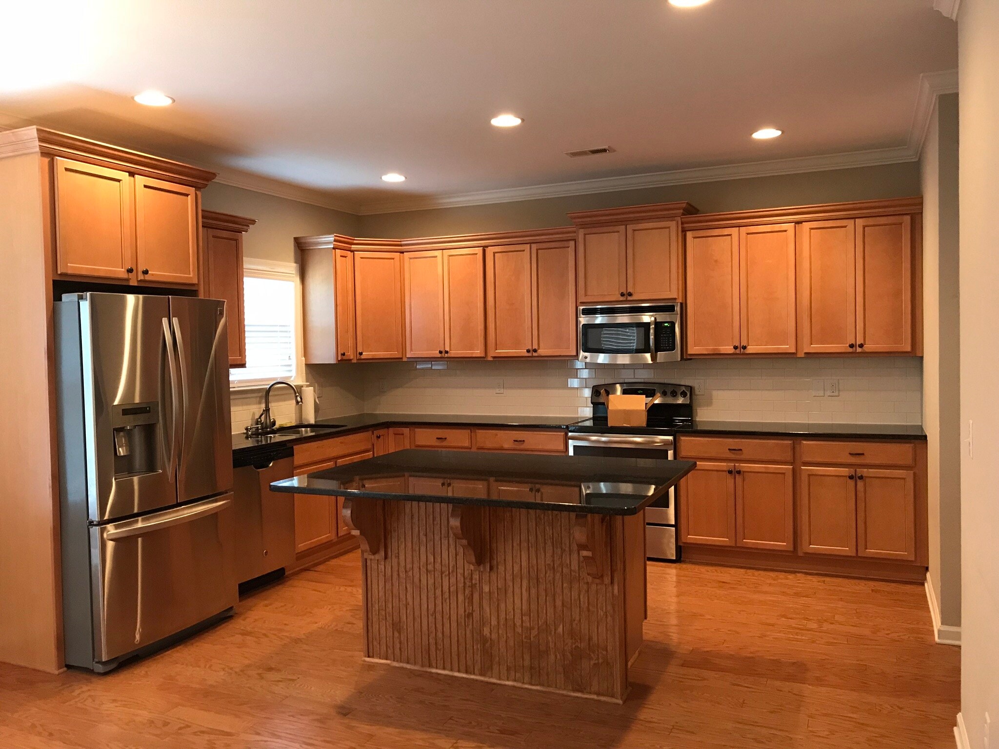 Open kitchen with granite counter tops and stainless appliances - 7506 Hampstead Hall Dr