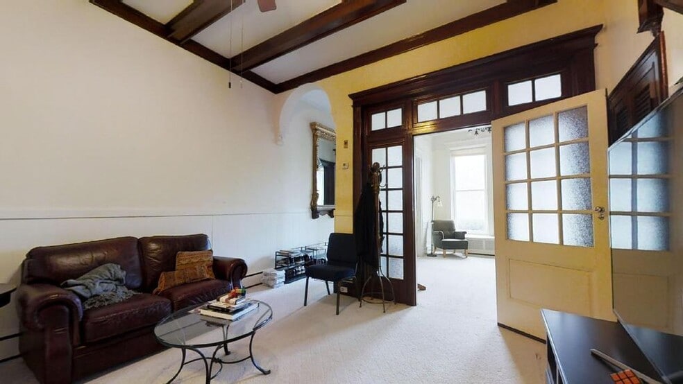 FRONT ENTRANCE HALLWAY WITH ANTIQUE MIRROR, WELCOME SPACE WITH VIEW TO LIVING ROOM THROUGH FRENCH DOORS - 2937 N Charles St