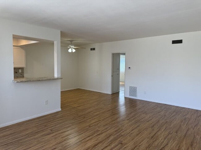 Apt #5: View from livingroom toward kitchen pass-thru window and hallway to bedrooms - 321 E Dryden St