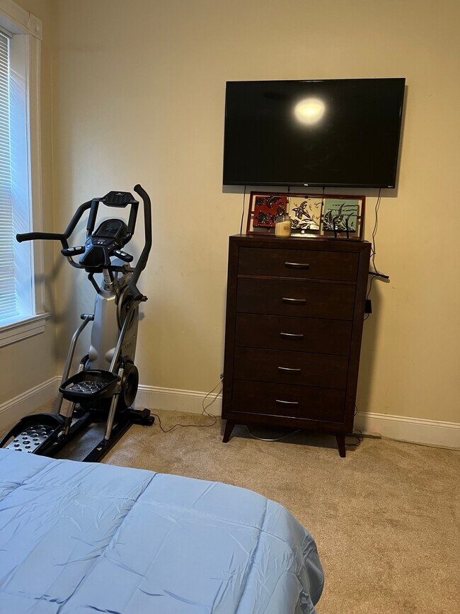 Primary Bedroom - Queen Sized Bed; 55-inch 4K Ultra Smart TV; Max Trainer 7 - 2219 Missouri Ave