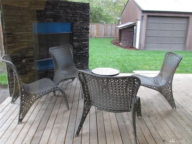 Covered patio with fireplace. There is now a fence added to the patio. - 15828 25th Ave NE