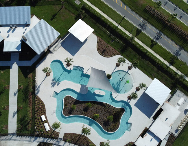 Aerial view of resort style pool with lazy river. - 31278 Amberview Bnd