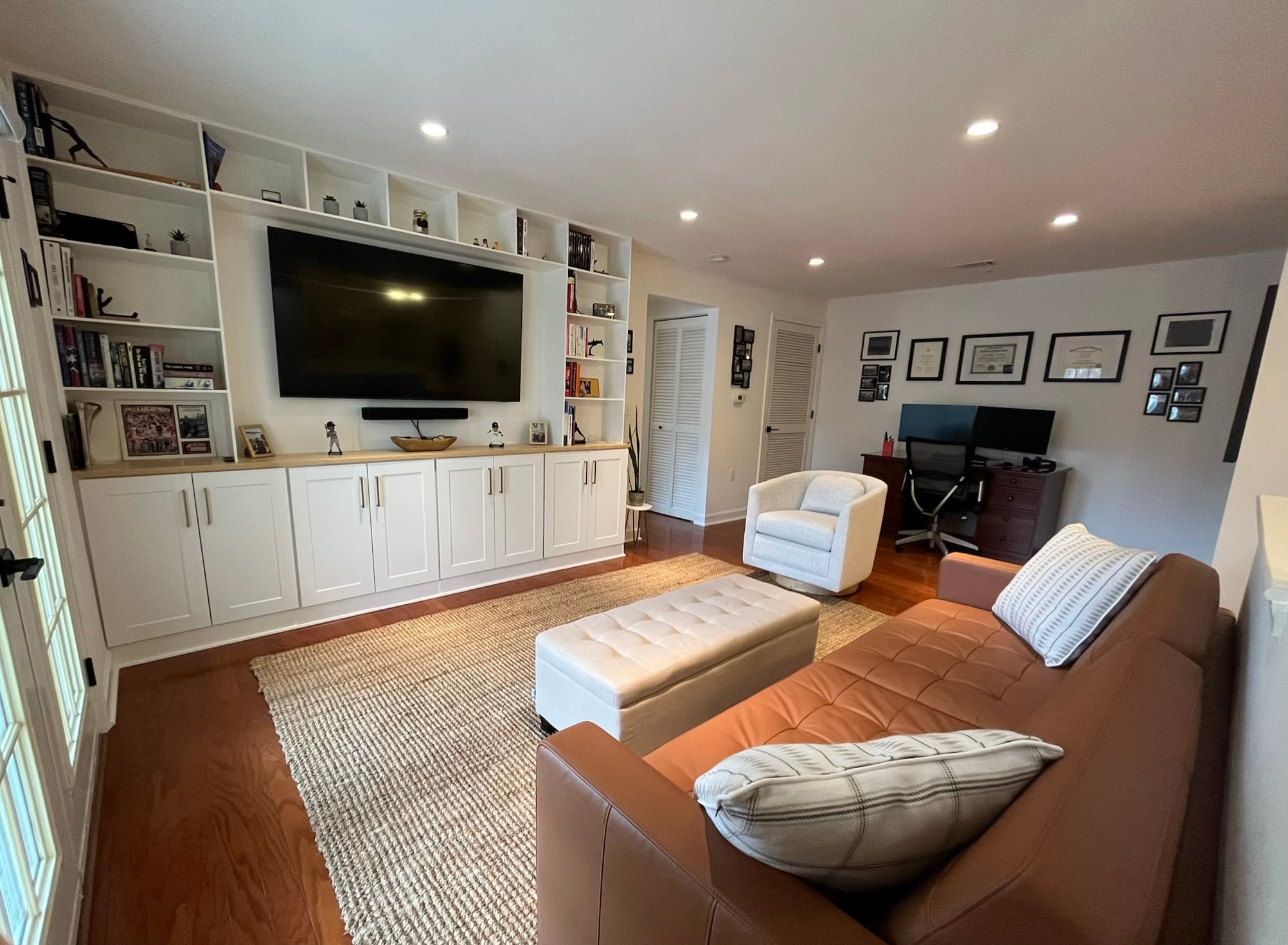 Spacious living room showing extensive built-in storage and natural light. - 4079 S Four Mile Run Dr