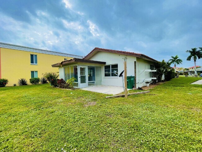 Building Photo - Updated 2-bedroom waterfront duplex with walk-in closets, enclosed Florida room, and canal views ...