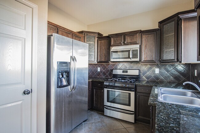 Building Photo - Beautiful 4-Bedroom Home with Custom Backy...