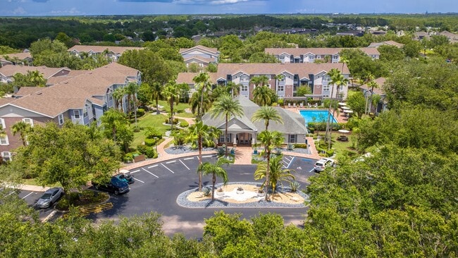 Discover the lush, resort-style layout of Ashton Chase Apartments—featuring vibrant landscaping, a sparkling pool, and spacious apartment homes. - Ashton Chase