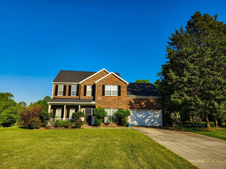 Front shot with brick exterior, double garage, and great curb appeal. - 7801 Peach Blossom Ct