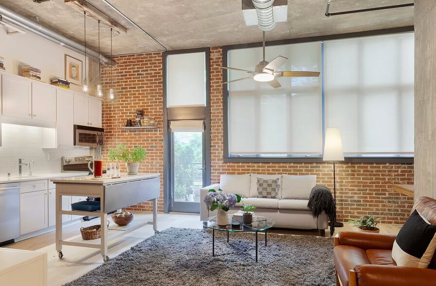 living room with automatic shades down - 640 Glen Iris Dr NE