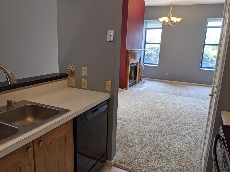 Living room with working woodturning fireplace and 15ft ceilings - 4496 Maryland Ave