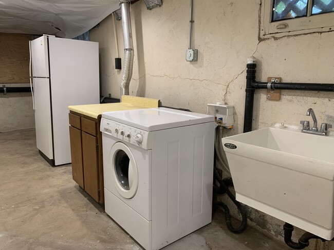 Lower Level Laundry and 2nd refrigerator. - 1023 SE Bidwell St