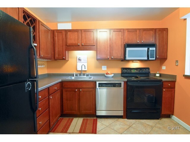 Kitchen w/ cherry stained cabinets - 211 E Ohio St