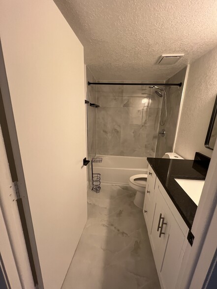 Second bathroom with white shaker cabinet and granite countertop - 1060 NW 80th Ave