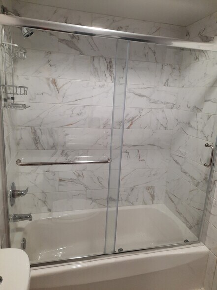 Guest bathroom bathtub/shower with calacatta gold ceramic tile - 434 Clinton Pl
