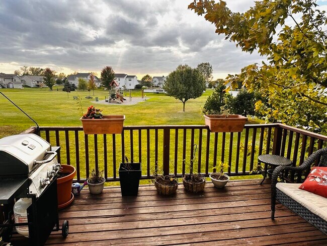 A deck overlooking an open backyard, perfect for outdoor gatherings and relaxation - 4555 Cider Wood Dr NW