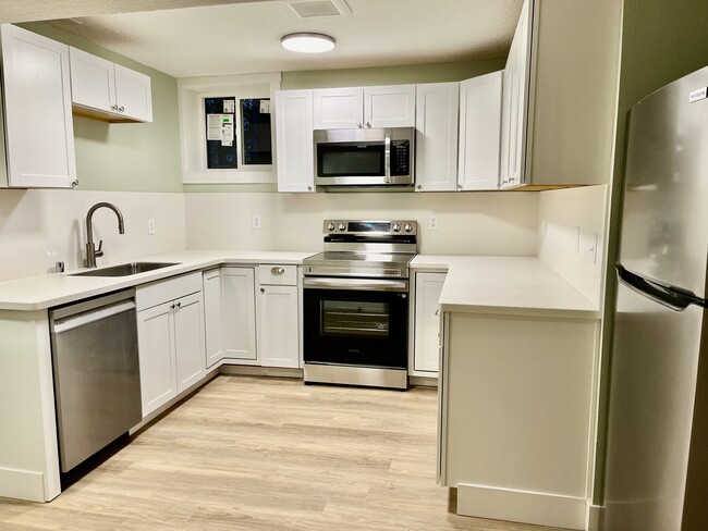 Spacious kitchen with so much storage, Corian countertops and backsplash. - 1401 W 13th Ave